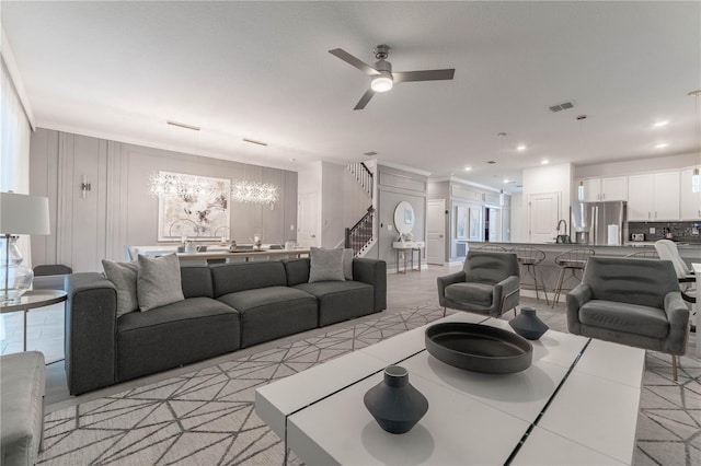 tiled living room featuring ceiling fan and sink