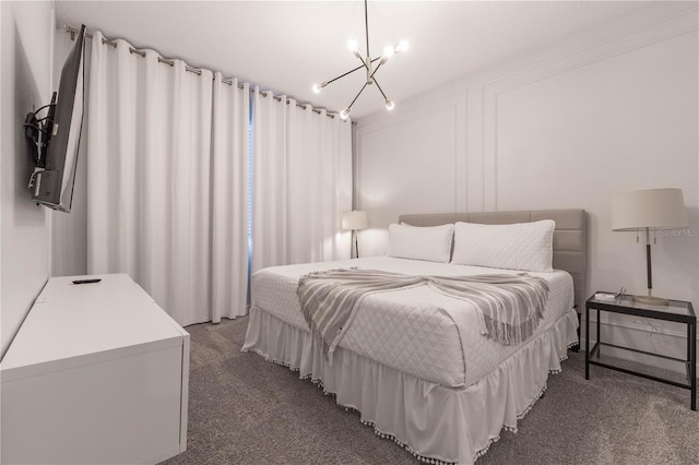 bedroom featuring dark carpet and a chandelier