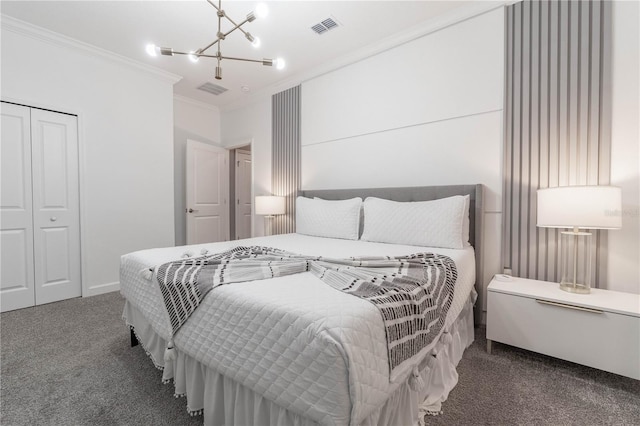 carpeted bedroom featuring a closet, a notable chandelier, and ornamental molding