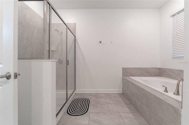 bathroom featuring tile patterned floors and shower with separate bathtub