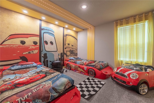 carpeted bedroom with multiple windows and a textured ceiling