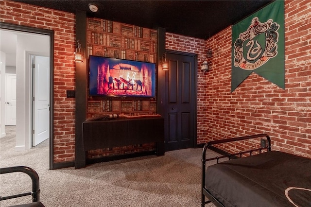 carpeted bedroom featuring brick wall