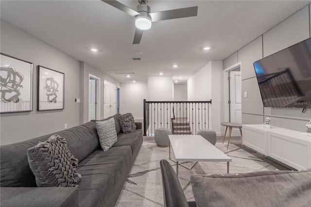 carpeted living room featuring ceiling fan