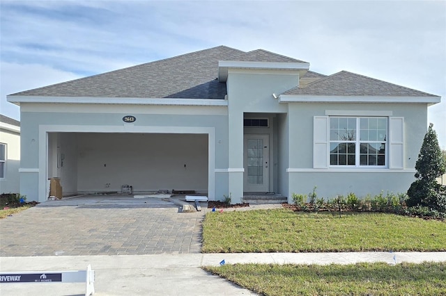 view of front of house featuring a garage and a front lawn