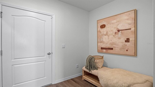 sitting room with dark hardwood / wood-style flooring