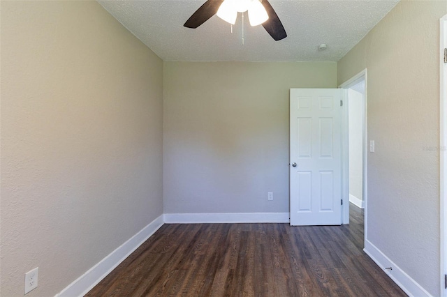 spare room with a textured ceiling, dark hardwood / wood-style floors, and ceiling fan