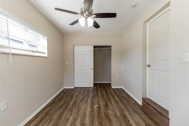 unfurnished bedroom featuring a closet, a textured ceiling, ceiling fan, and dark hardwood / wood-style floors