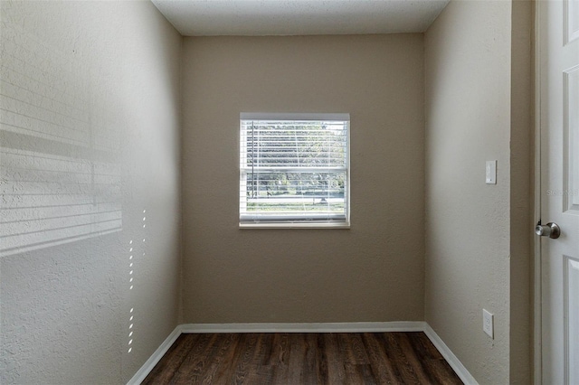 spare room with dark hardwood / wood-style floors