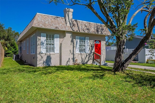 view of front of home featuring a front yard and cooling unit