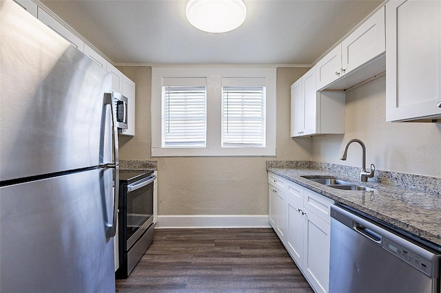 kitchen with sink, appliances with stainless steel finishes, dark wood-type flooring, and white cabinets