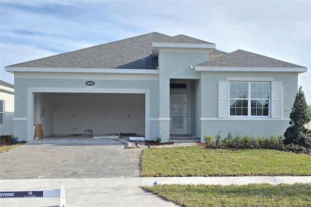 prairie-style home featuring a garage and a front yard