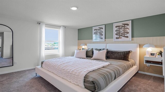 bedroom with a textured ceiling and carpet