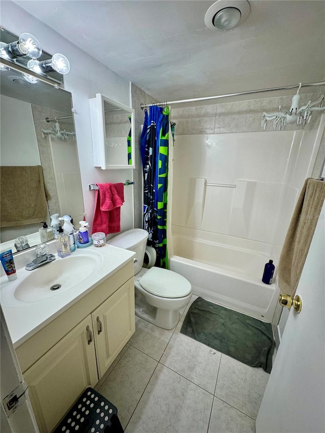 full bathroom featuring vanity, toilet, tile patterned floors, and shower / tub combo