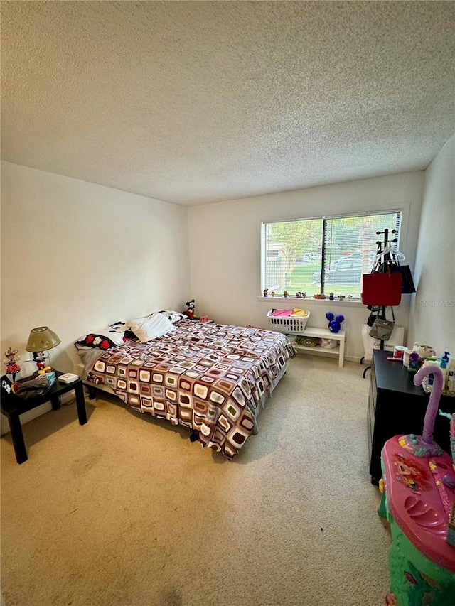 bedroom with a textured ceiling and carpet floors