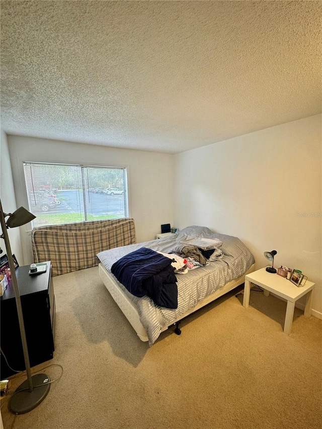 carpeted bedroom featuring a textured ceiling