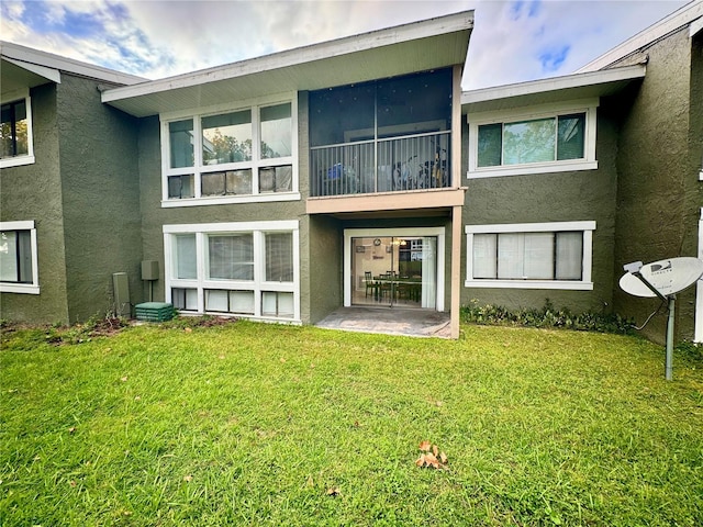 rear view of house with a yard and a patio area