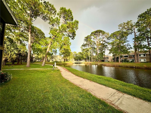 view of community featuring a yard and a water view