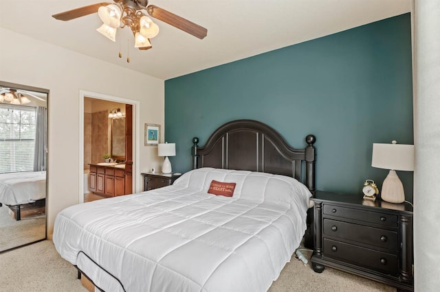 carpeted bedroom featuring connected bathroom and ceiling fan