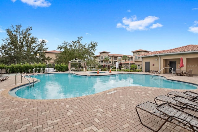 view of swimming pool with a patio