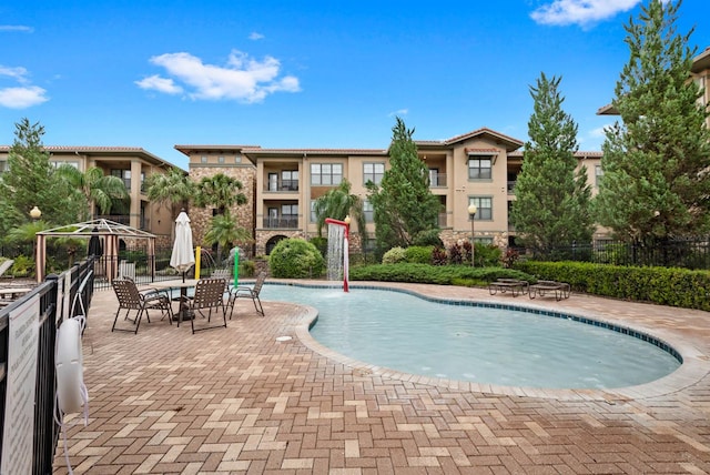 view of swimming pool featuring a patio area and pool water feature