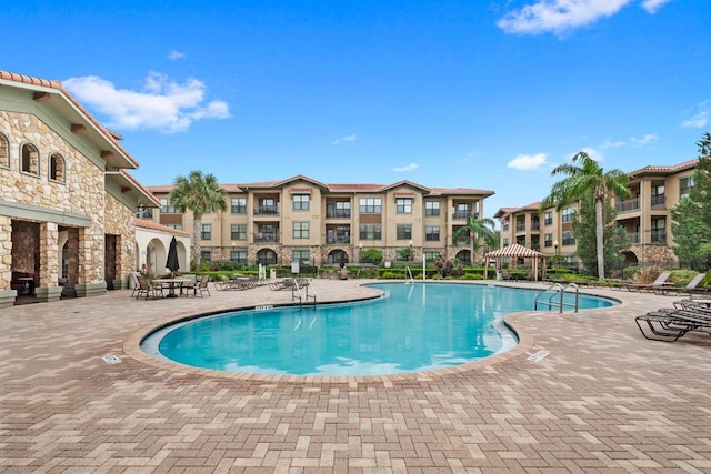 view of swimming pool featuring a patio area