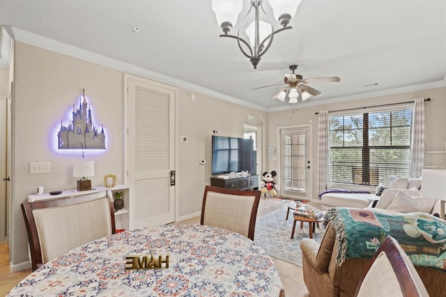 dining room featuring baseboards, visible vents, ornamental molding, and ceiling fan with notable chandelier