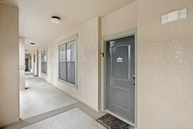 property entrance with stucco siding