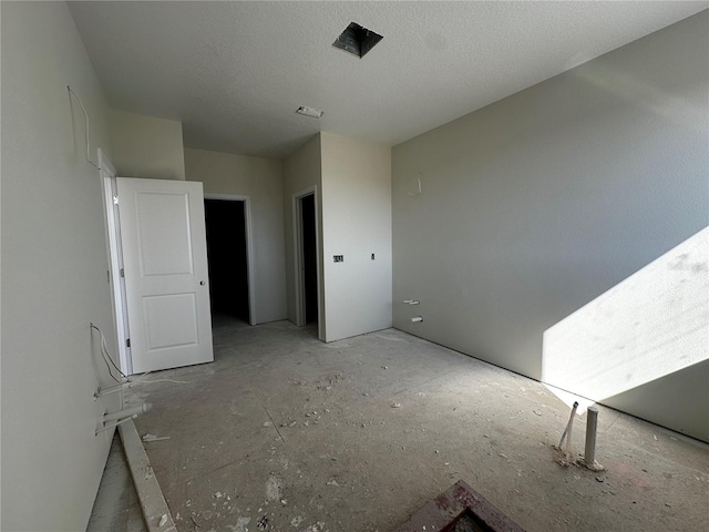 unfurnished room featuring a textured ceiling