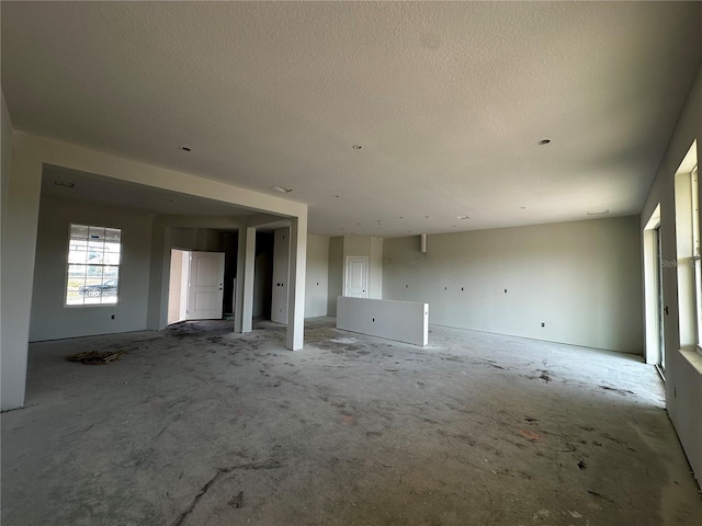 unfurnished living room with a textured ceiling