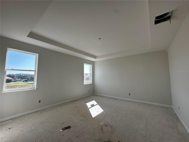 unfurnished room with a tray ceiling