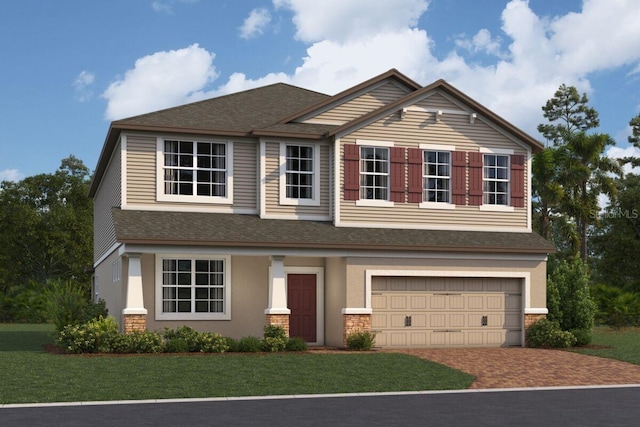 view of front of house featuring a garage and a front lawn