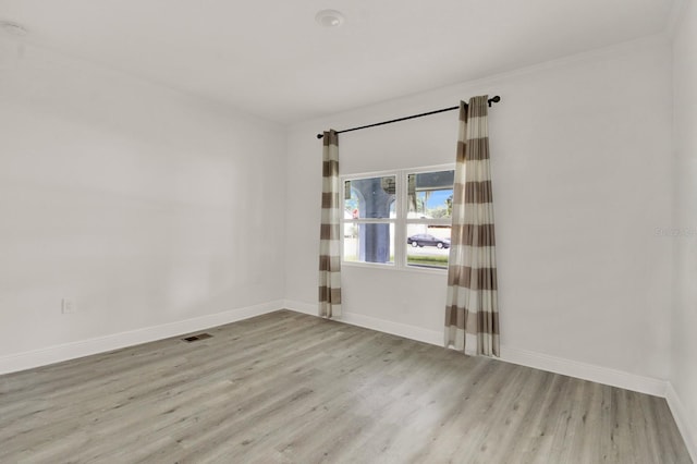 empty room with light hardwood / wood-style floors