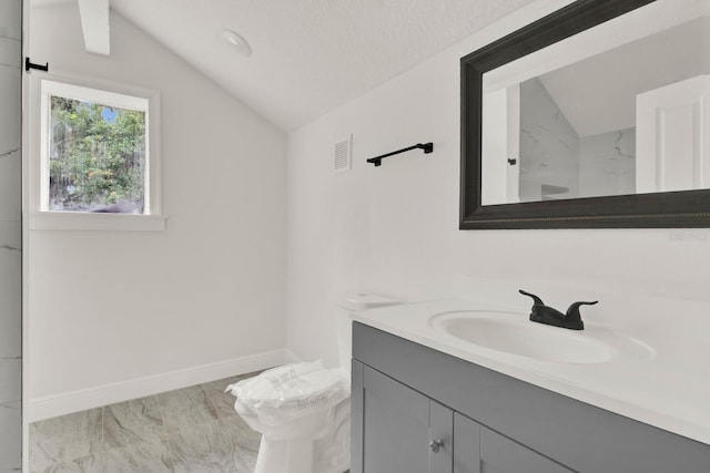 bathroom featuring vanity, toilet, a textured ceiling, and vaulted ceiling