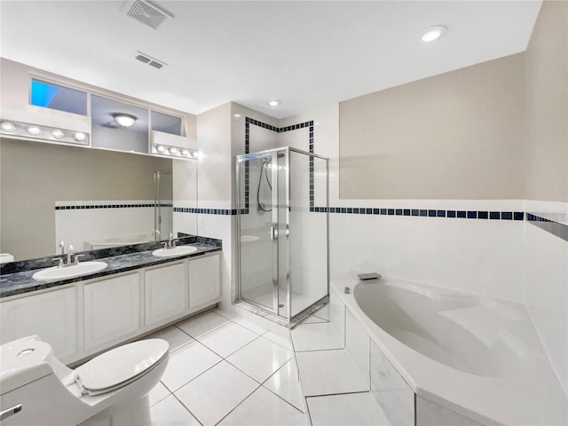 full bathroom featuring toilet, shower with separate bathtub, vanity, and tile patterned floors