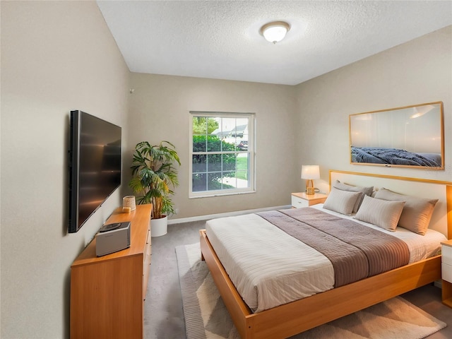 carpeted bedroom featuring a textured ceiling