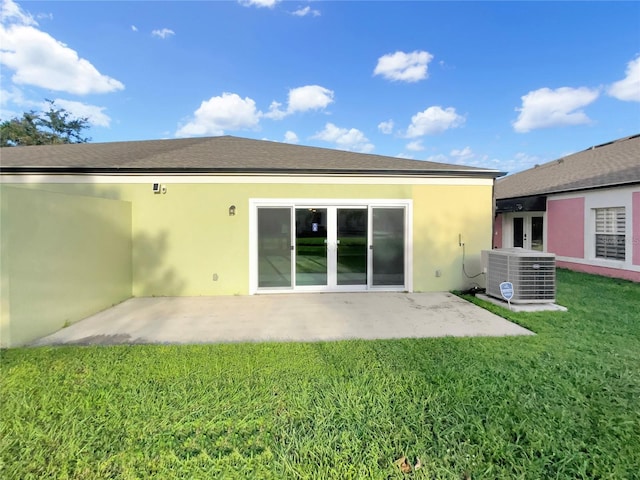 back of property with a yard, a patio area, and cooling unit