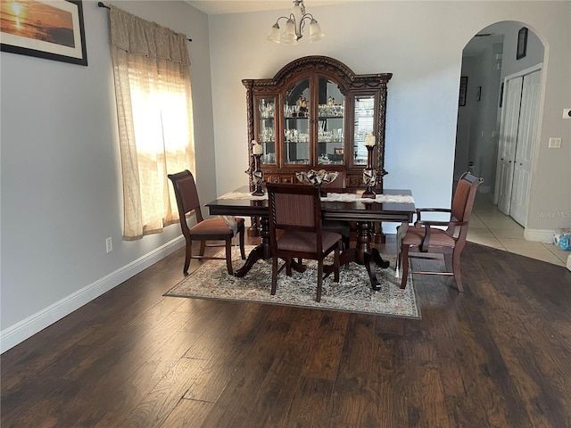 dining area featuring a notable chandelier and hardwood / wood-style flooring