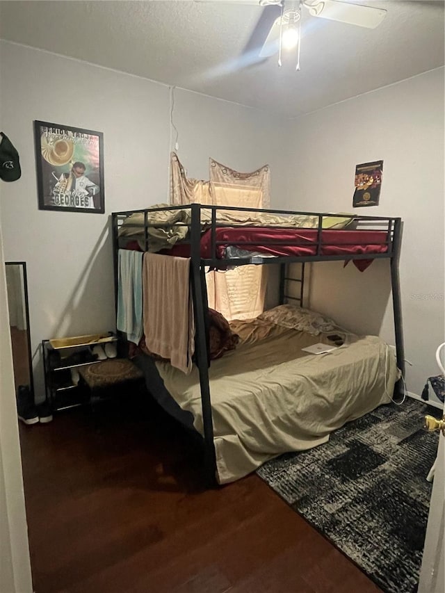 bedroom with wood-type flooring and ceiling fan