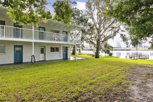 view of yard with a water view and a balcony