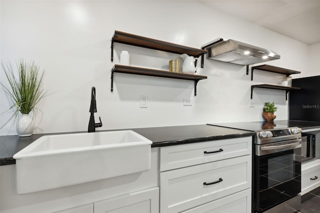 kitchen with white cabinets, exhaust hood, stainless steel electric range oven, dark tile patterned flooring, and sink