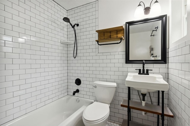 full bathroom with tile walls, tiled shower / bath combo, and toilet