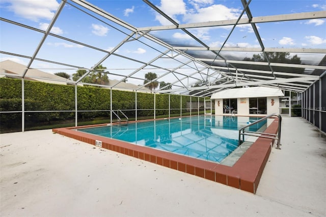 view of pool with a patio and glass enclosure