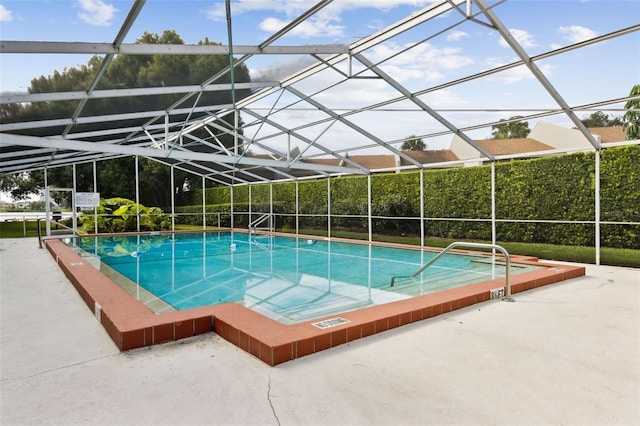 view of swimming pool with a patio and a lanai