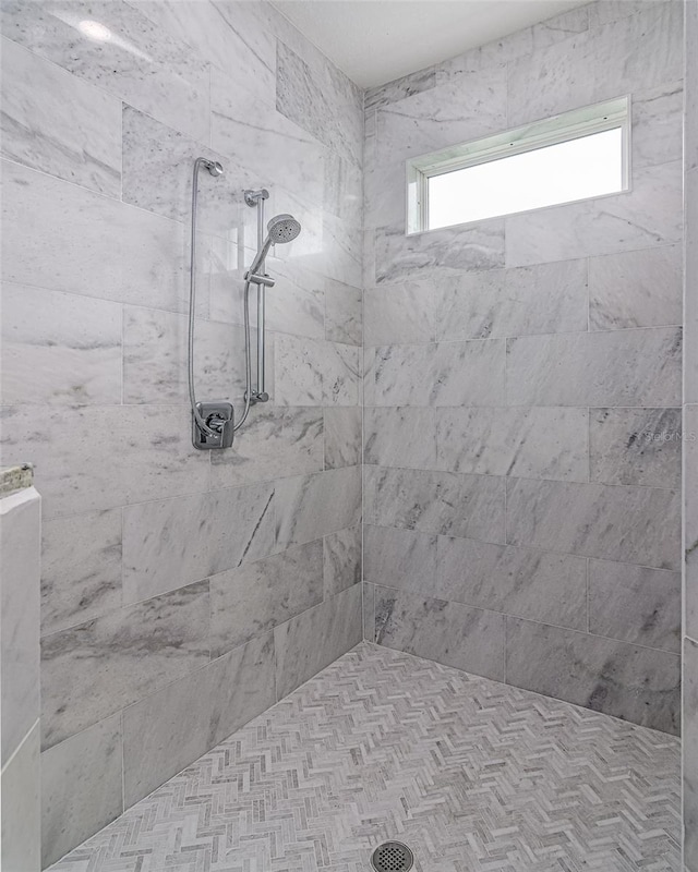 bathroom with tiled shower