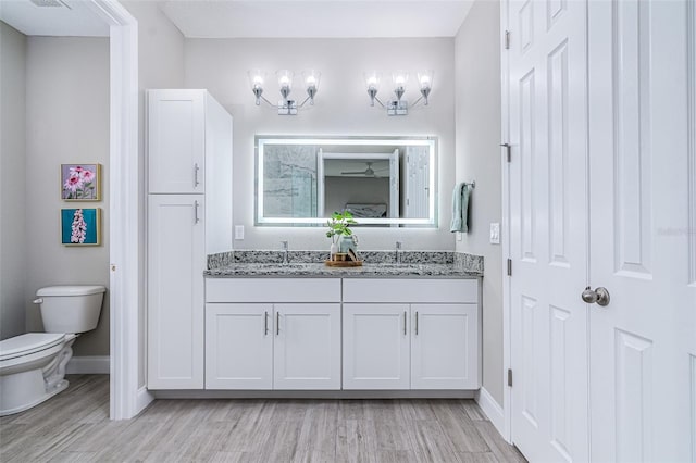 bathroom with vanity, hardwood / wood-style floors, and toilet