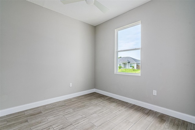 empty room with light hardwood / wood-style flooring and ceiling fan