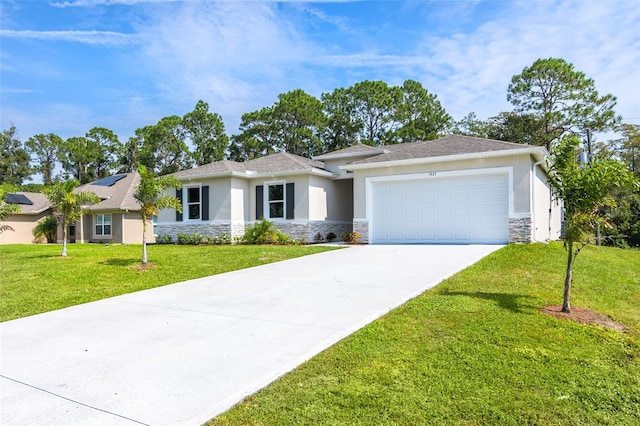 view of front of property featuring a garage and a front lawn