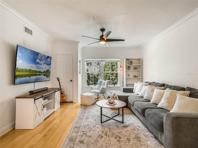 living room featuring crown molding, hardwood / wood-style flooring, and ceiling fan