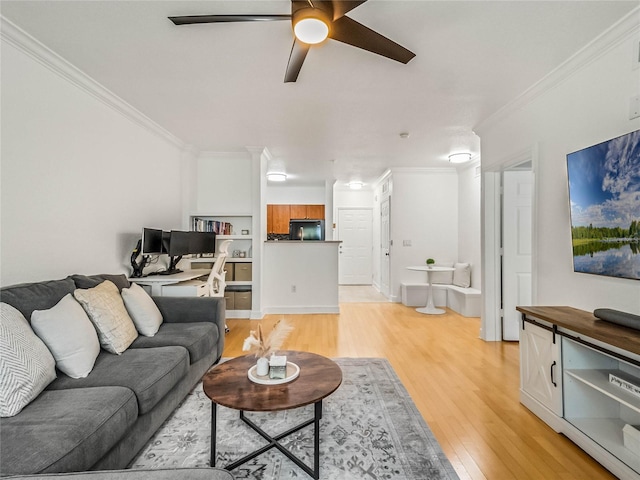 living room with light hardwood / wood-style floors, ornamental molding, and ceiling fan