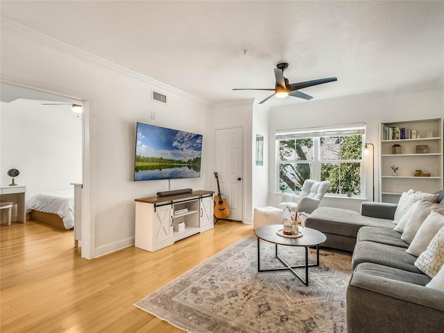 living room featuring ornamental molding, hardwood / wood-style floors, and ceiling fan